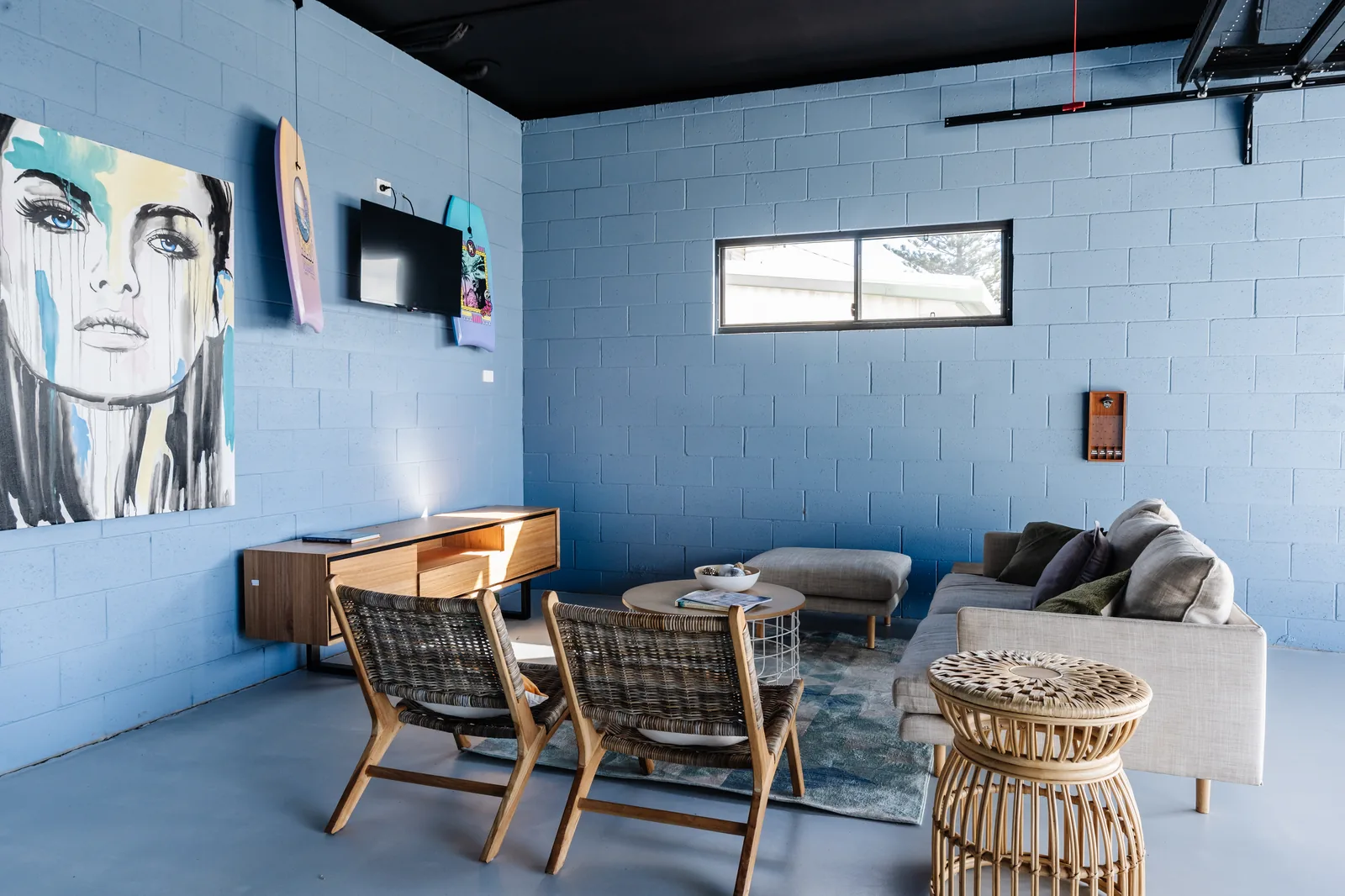 Man cave with pop-art portrait and bodyboards